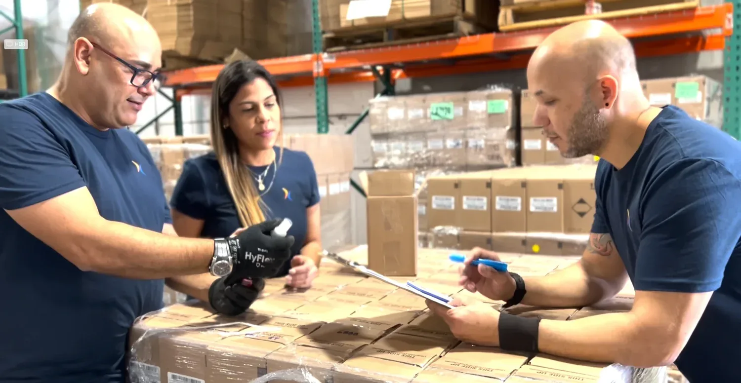 DC Logistics US team checking prepped cartons on a pallet in the Orlando warehouse